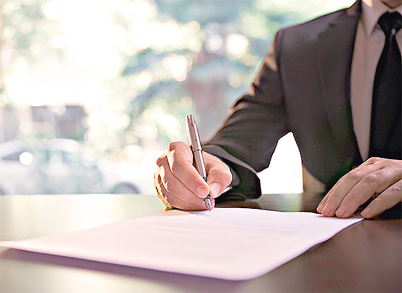 Businessman Signing Contract or Legal Papers