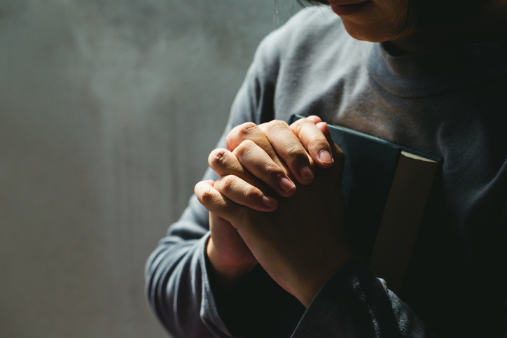 Women in religious concepts Hands praying to God.Women holding the Bible May the blessings of God