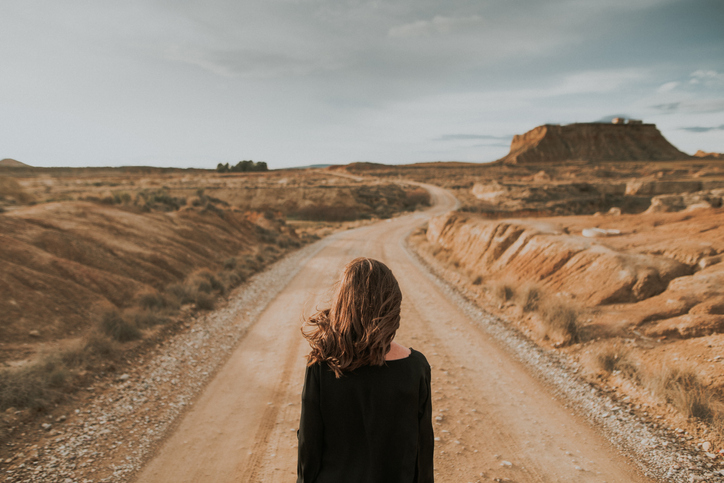 Rear view of woman at desert road