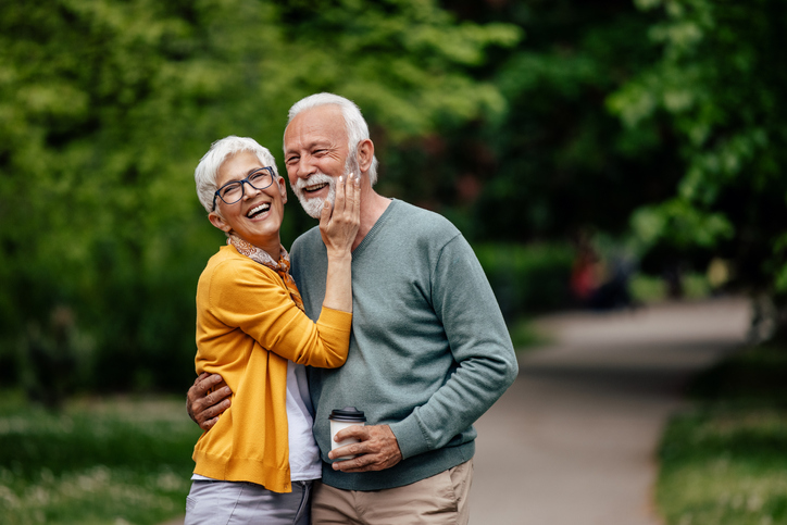 Relaxed mature man, being gently touched by his wife.