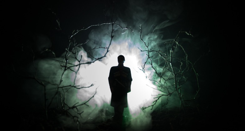 strange-silhouette-in-a-dark-spooky-forest-at-night-mystical-surreal-picture-id934806770