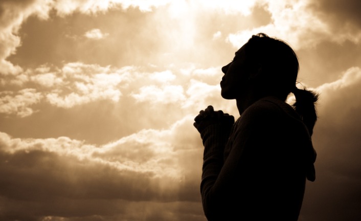 silhouette-of-a-woman-looking-at-the-sky-praying-picture-id173628717