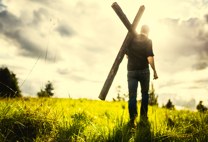 Man Carrying Cross of Christ on His Shoulder