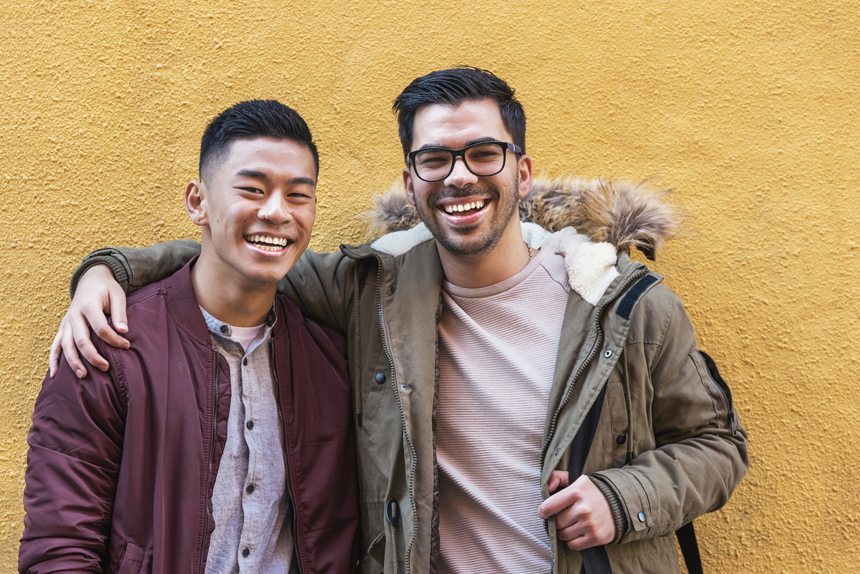 Portrait of group of friends looking the camera in the street.