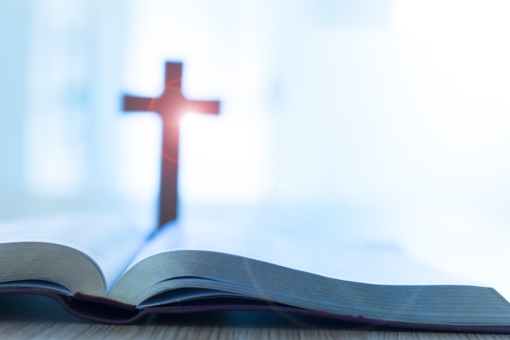 Bible and cross on desk