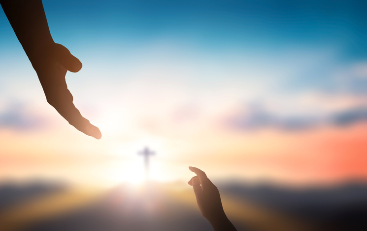 Help hand of God reaching over blurred cross on sunrise  background Help hand of God reaching over blurred cross on sunrise  background