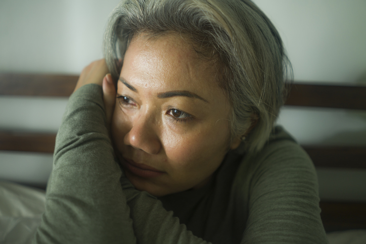 mature lady crisis &#8211; attractive middle aged woman with grey hair sad and depressed in bed feeling scared and lonely thinking worried about covid-19 virus pandemic during home lockdown