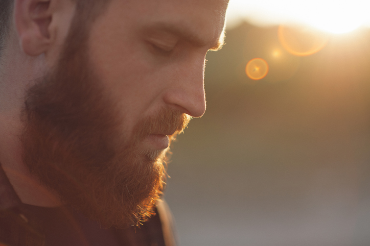 young bearded man with eyes closed