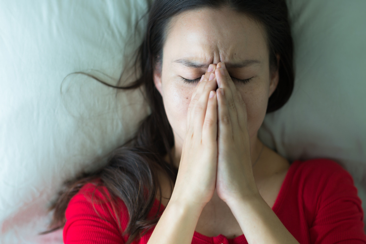 Stressed sad woman covering her face.