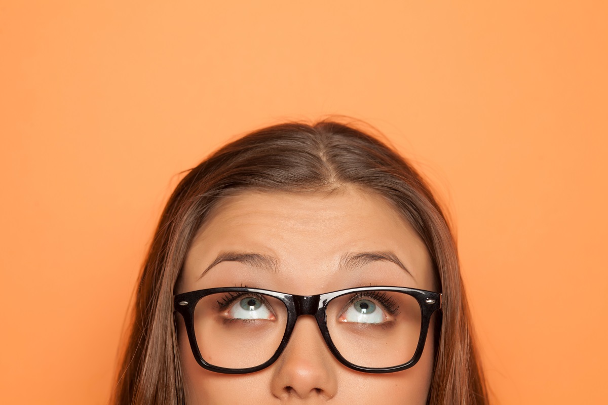 Half,Portrait,Of,A,Young,Girl,With,Glasses,Looking,Up