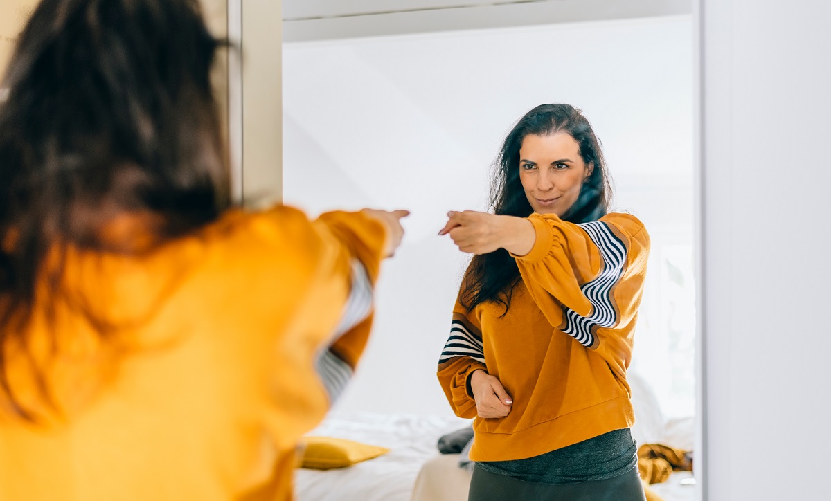 Self,Confident,Single,Woman,Pointing,Finger,At,Her,Reflection,In