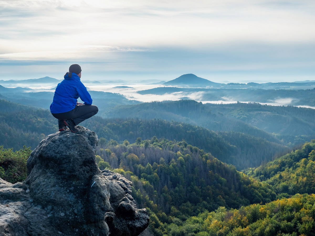 Hiker,Sit,On,Cliff,And,Looking,Beautiful,Landscape.,Tourist,Watching