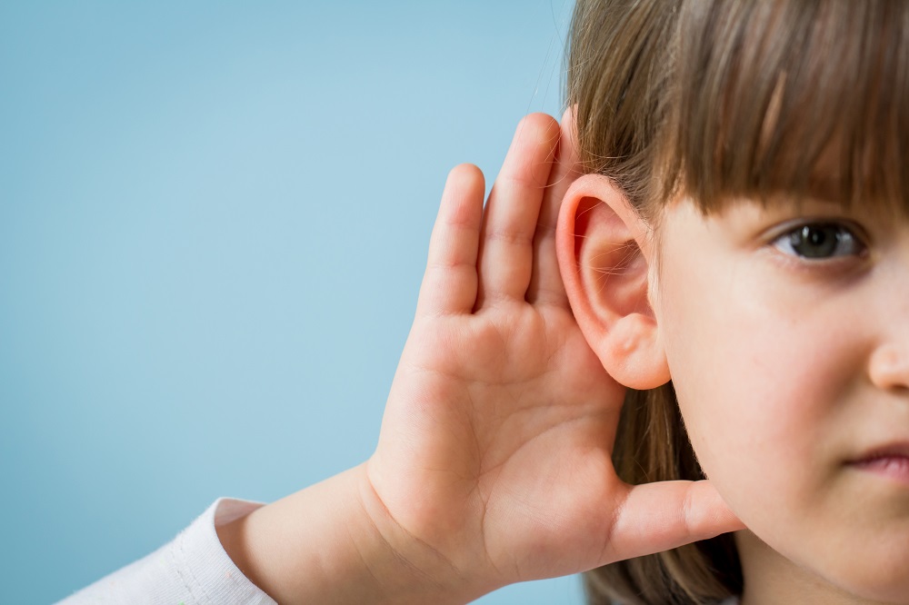 Child,With,Hearing,Problem,On,Blue,Background.,Hearing,Loss,In