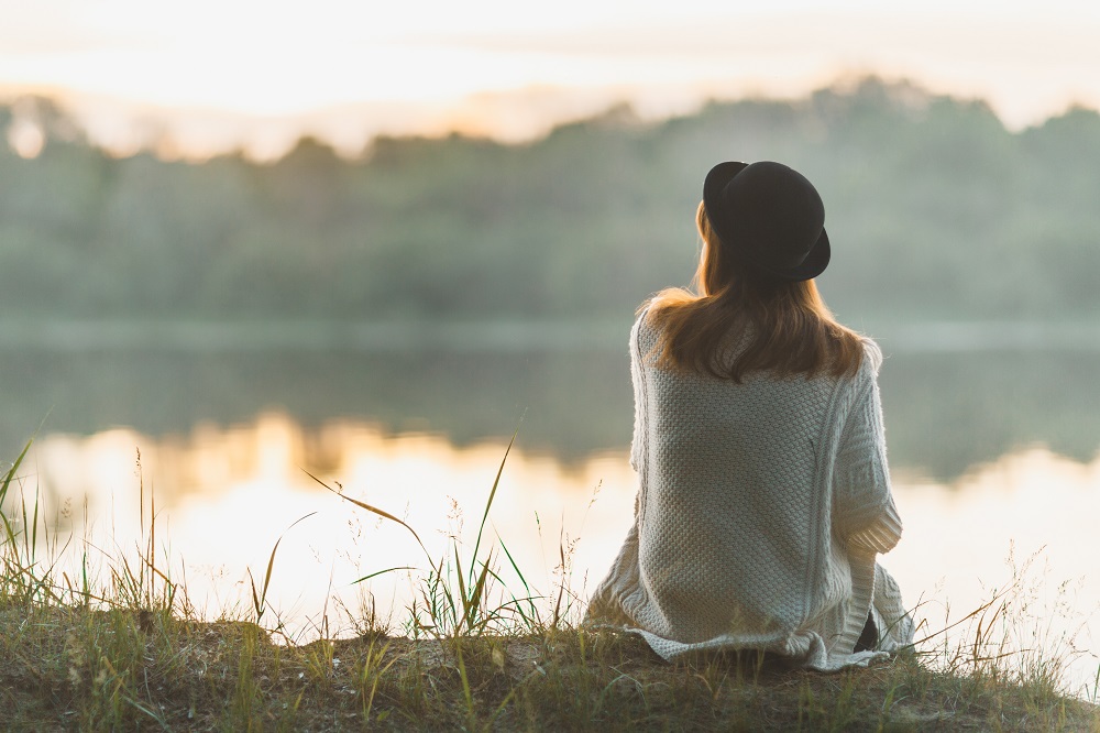 A,Girl,Sitting,On,The,River,Bank,In,Silence