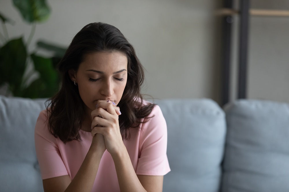 Worried,Anxious,Young,Arabian,Woman,Sit,On,Couch,Praying,God