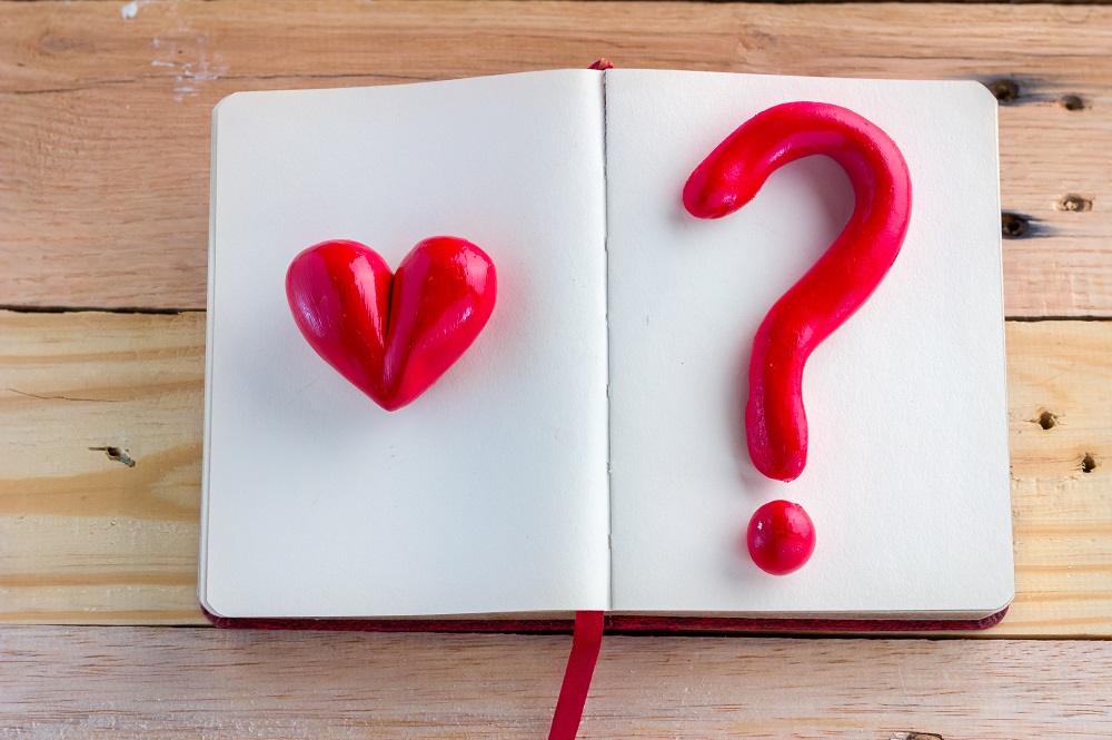 Heart,And,Question,Mark,Red,Symbol,On,Notebook,On,Wooden