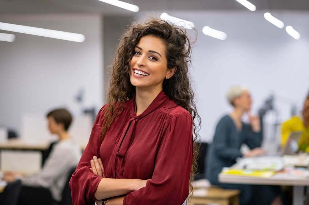 Successful,Businesswoman,Standing,In,Creative,Office,And,Looking,At,Camera