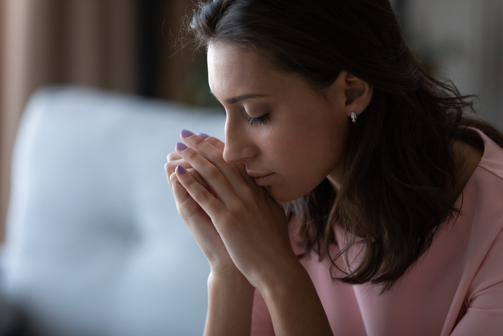 Close up of unhappy Arabian woman lost in thoughts