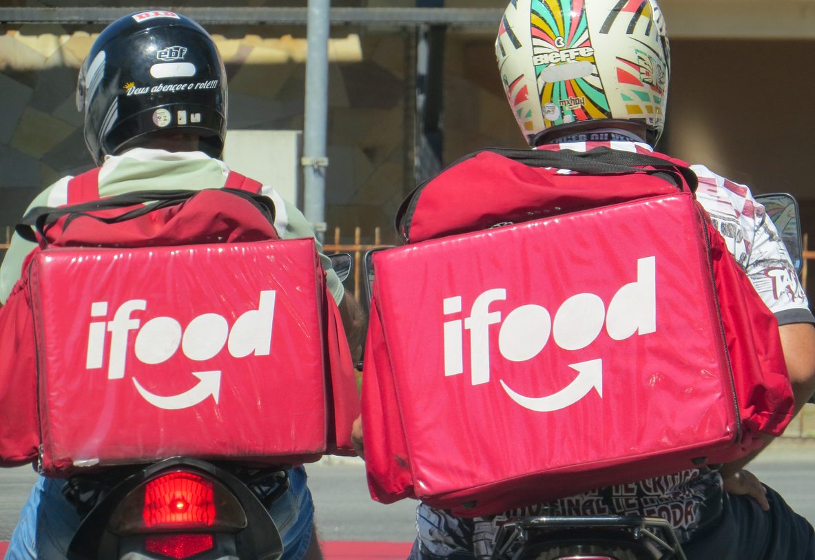 Two motorcyclists, Ifood employees deliver food to customers in the city.