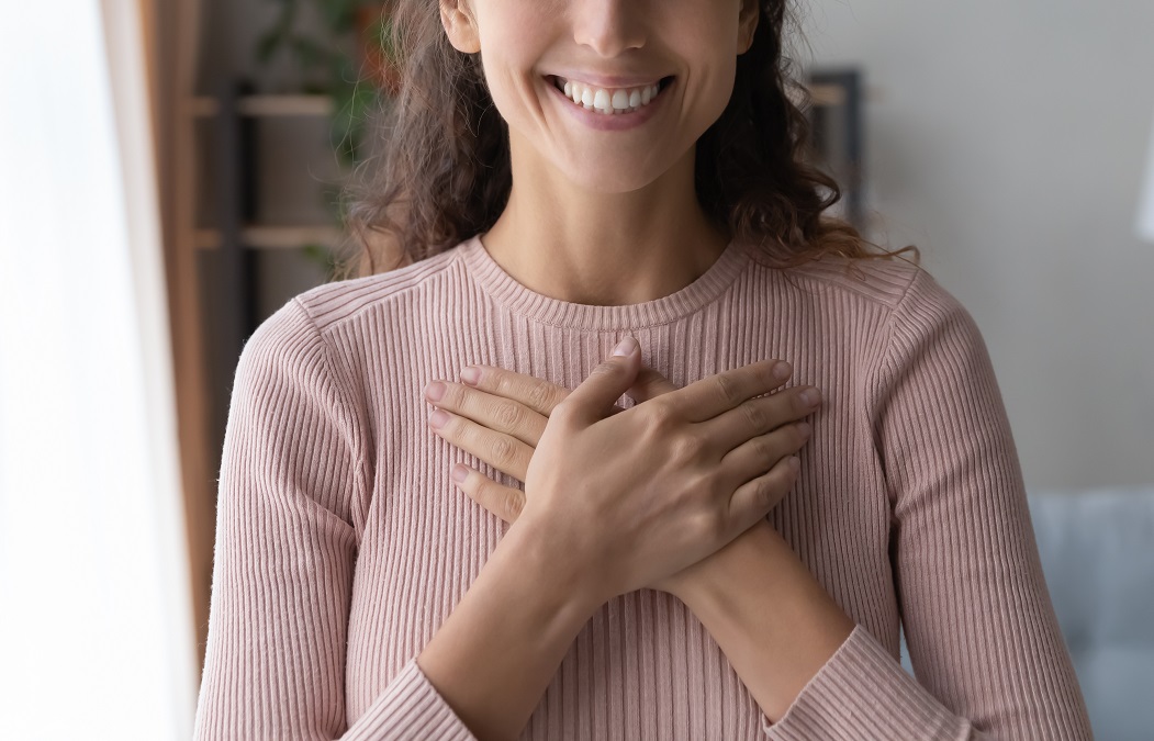 Close,Up,Focus,On,Happy,Sincere,Female,Holding,Folded,Hands