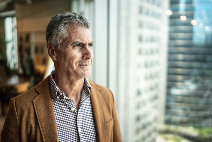 Mature businessman looking out of window
