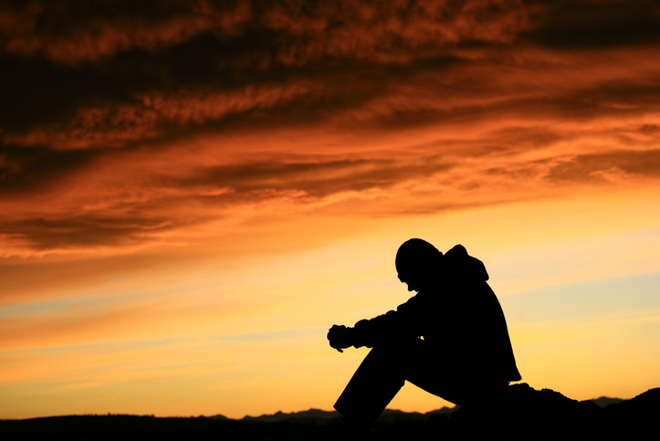 Silhouette of Young Man Contemplating Life