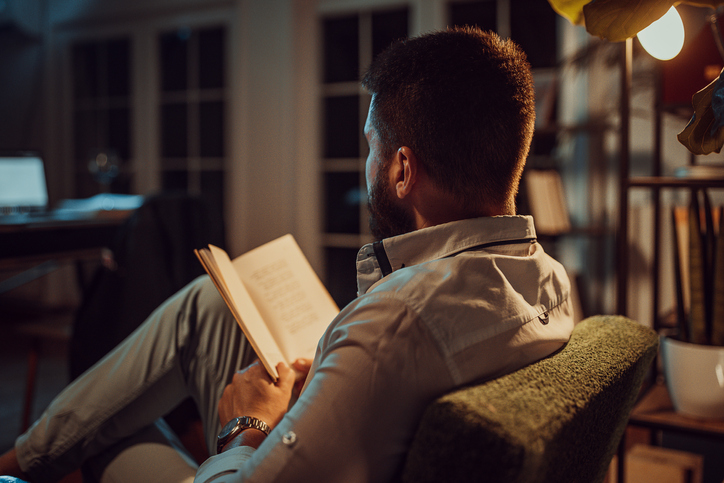 Man reading a book at home