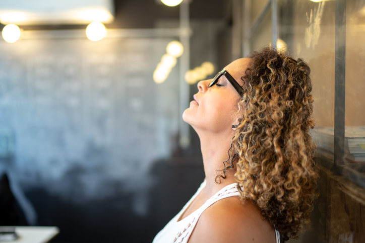 Frustrated latinx woman feeling loser standing at the office