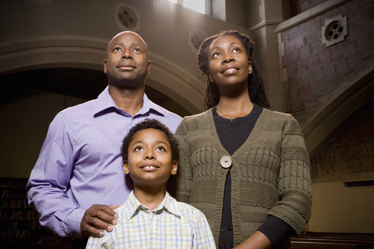 Family Standing and Praying in Church