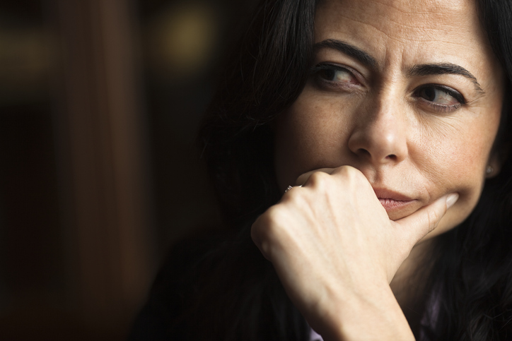 Portrait of a pensive woman with a furrowed brow