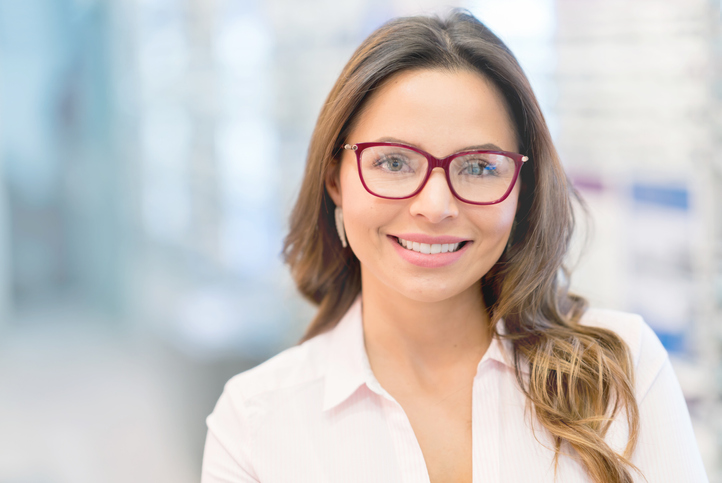 Beautiful woman wearing glasses at the optical shop