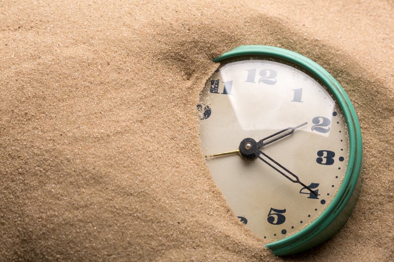 Alarm clock in sand