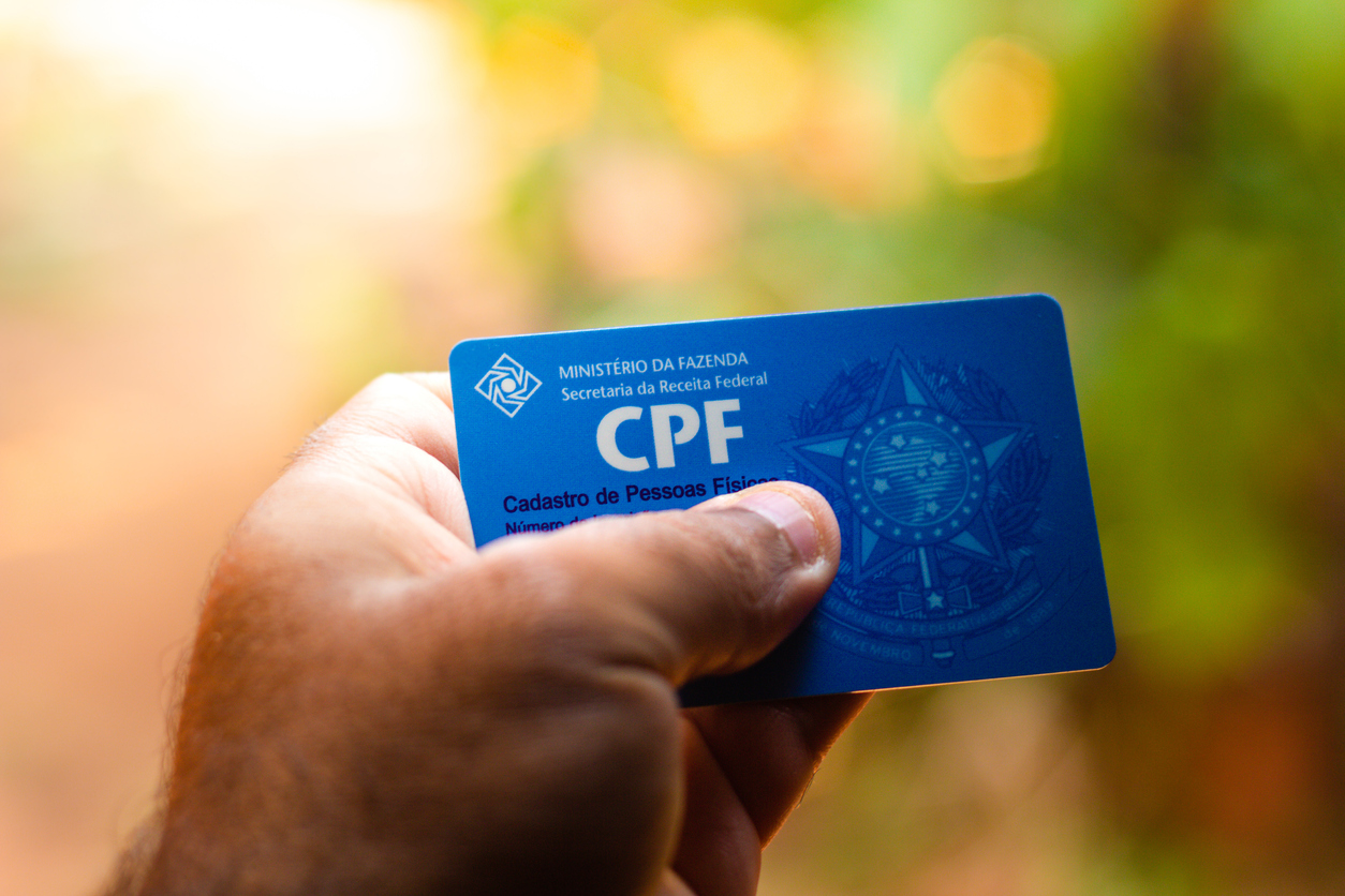 Man holding document  &#8211; Cadastro de Pessoa Física &#8211; (CPF). The document guarantees authenticity and integrity in electronic communication between people in Brazil