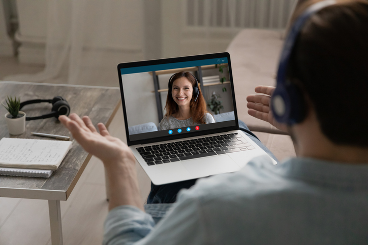 Happy man in headphones holding video call talk with girlfriend.