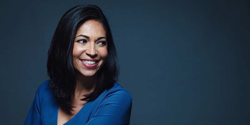 Happy smiling hispanic woman looking away