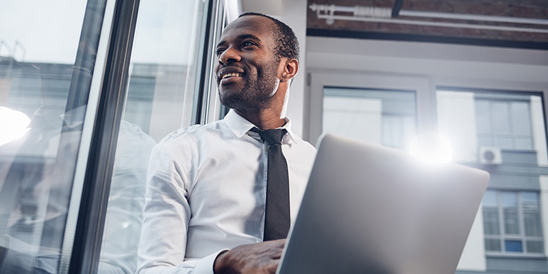 Joyful pleasant businessman is enjoying city landscape