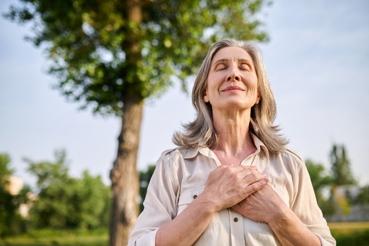 Happy woman folded hands on her chest
