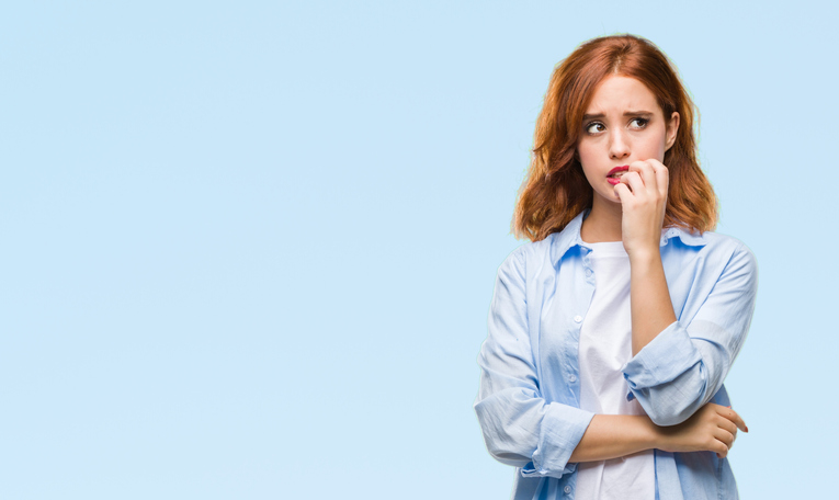 Young beautiful business woman over isolated background looking stressed and nervous with hands on mouth biting nails. Anxiety problem.