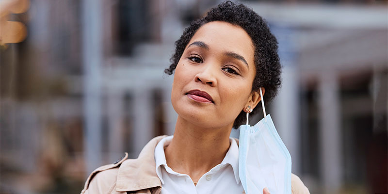 Woman in city, remove face mask at end of covid disease infection and health policy change portrait. Corona virus quarantine is over, vaccine safety in outdoor urban air or protection from pollution