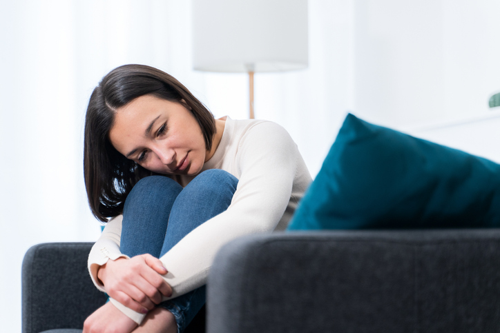 Portrait of a lonely sad woman deep in thoughts