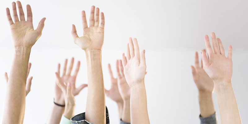 People’s hands raised in air