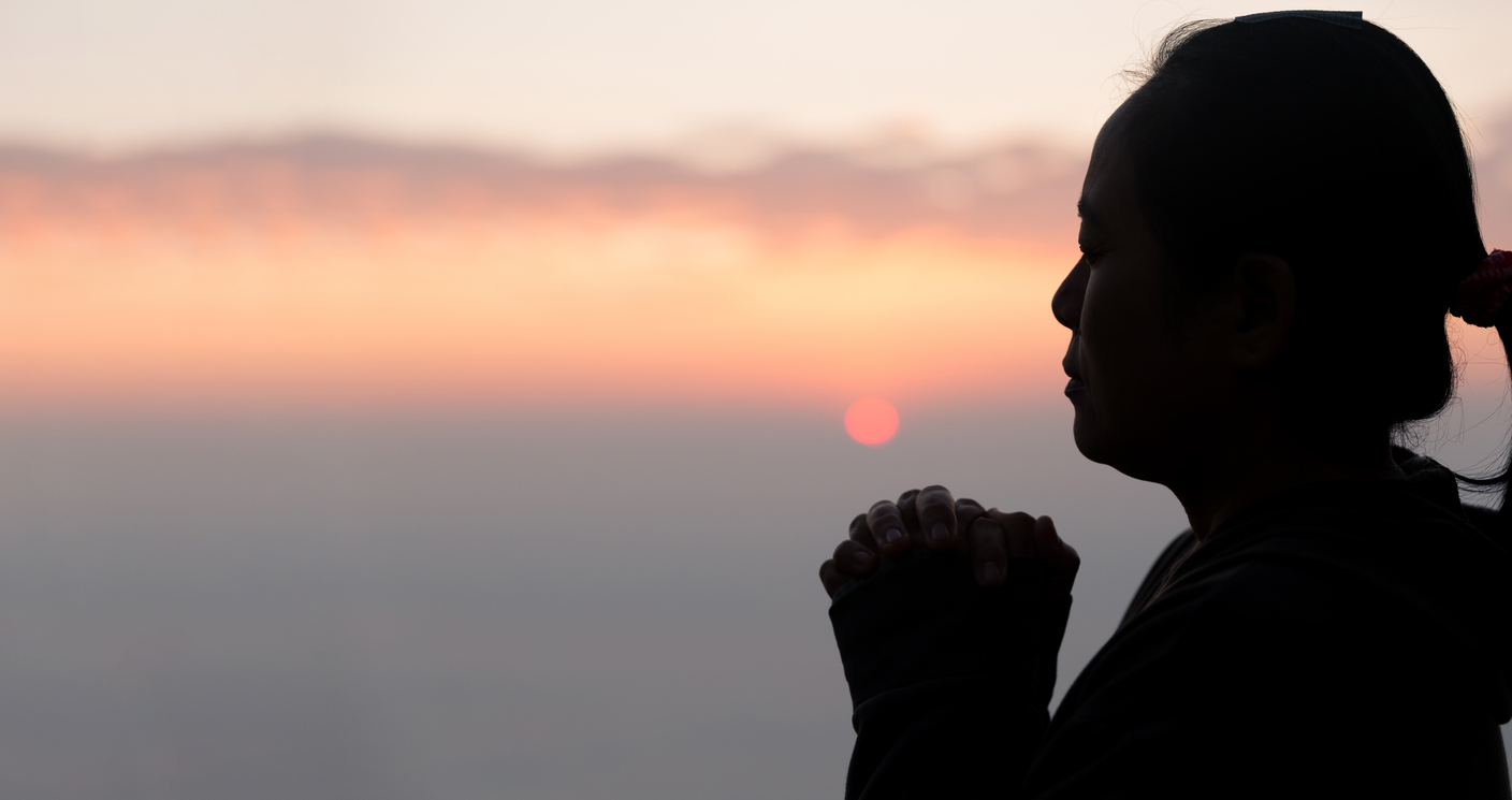 Silhouette of woman hand praying spirituality and religion, female worship to god. Christianity religion concept. Religious people are humble to God. Christians have hope faith and faith in god.