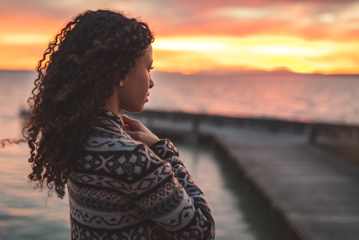 Thoughtful evening mood with a young afro latino woman