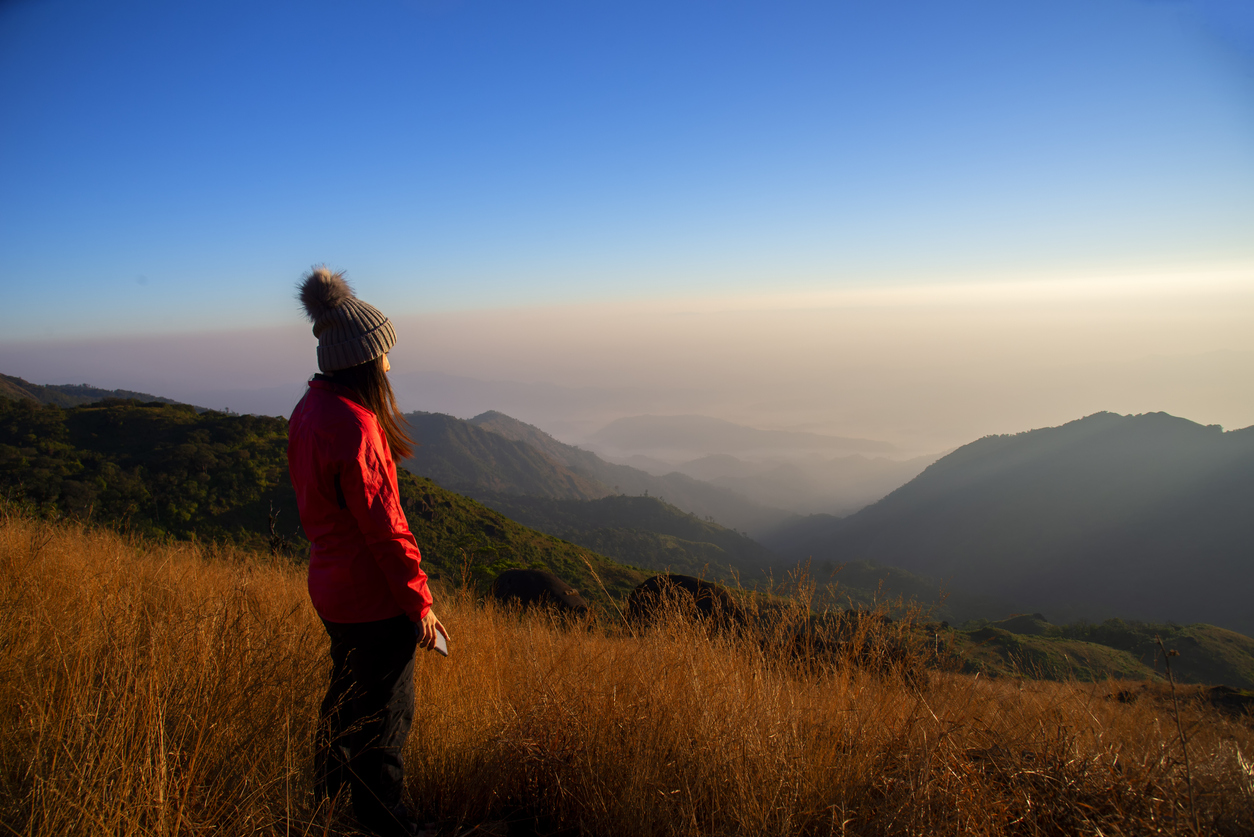 Hiker asian woman happy feeling freedom good and strong weight victorious facing on the natural mountain. Travel Concept