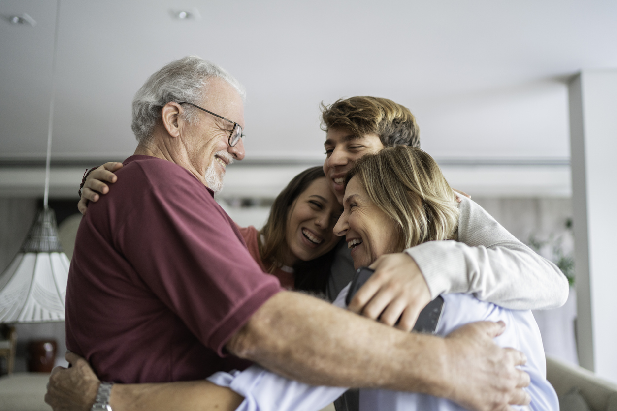 Grandchild and grandparents embracing