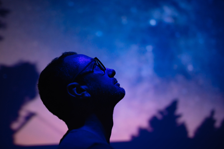 Silhouette of a man with Milky Way starry skies.