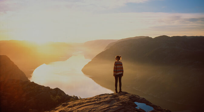 Woman hiking in mountains on the background of Lysefjorden