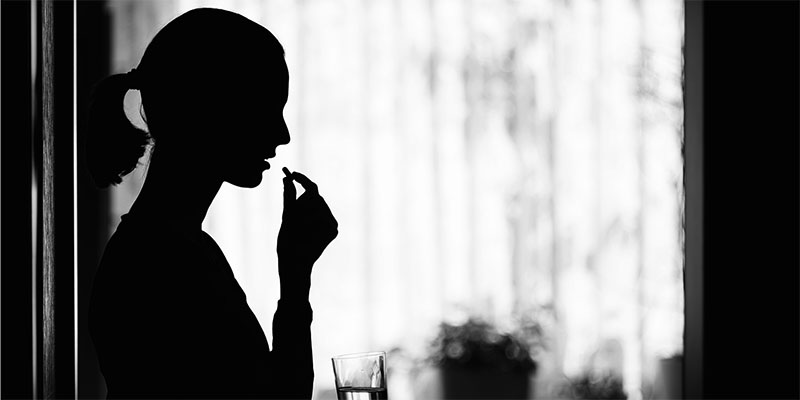 Woman taking pill