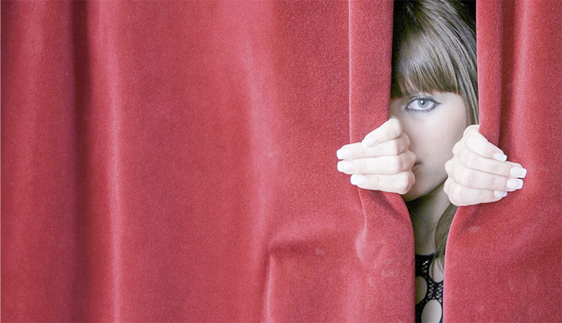 Looking through red curtains