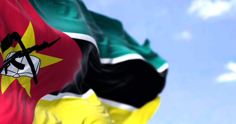 Detail of the national flag of Mozambique waving in the wind on a clear day